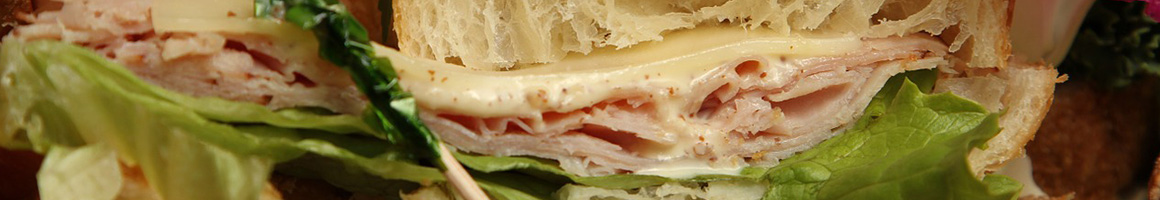 Eating Deli Sandwich at The Bread Basket Deli restaurant in Tampa, FL.